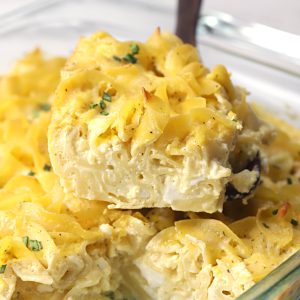 A baked kugel is being served with a spatula.