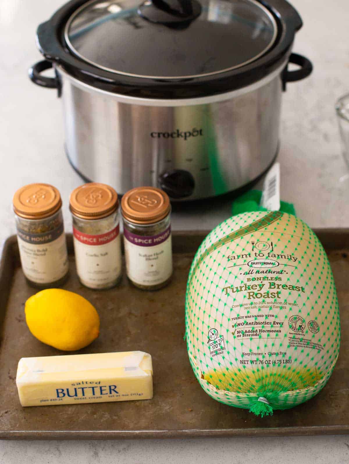 The boneless turkey breast sits on a tray next to the seasonings.