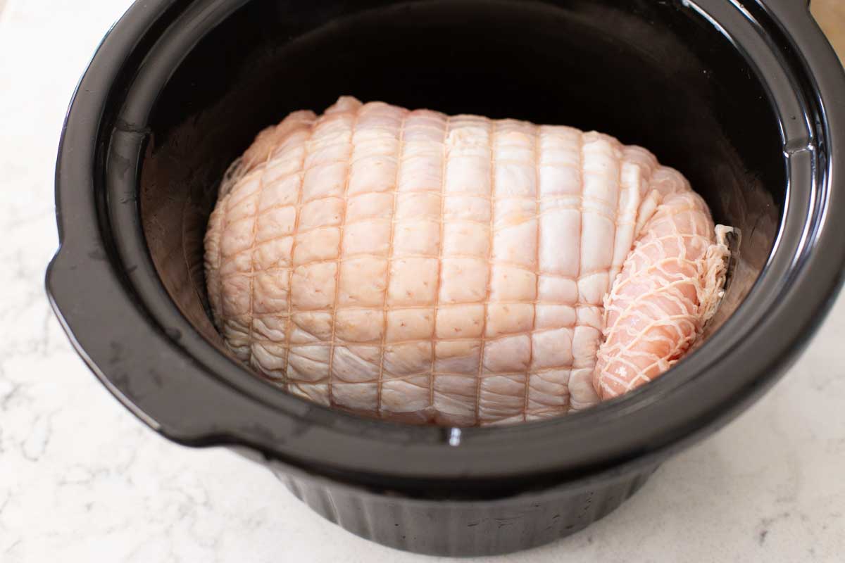 The turkey breast waits inside the slow cooker.