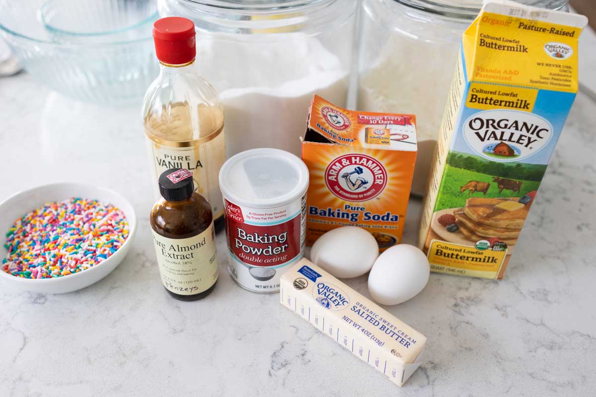 The ingredients to make homemade birthday cake waffles are on the counter.