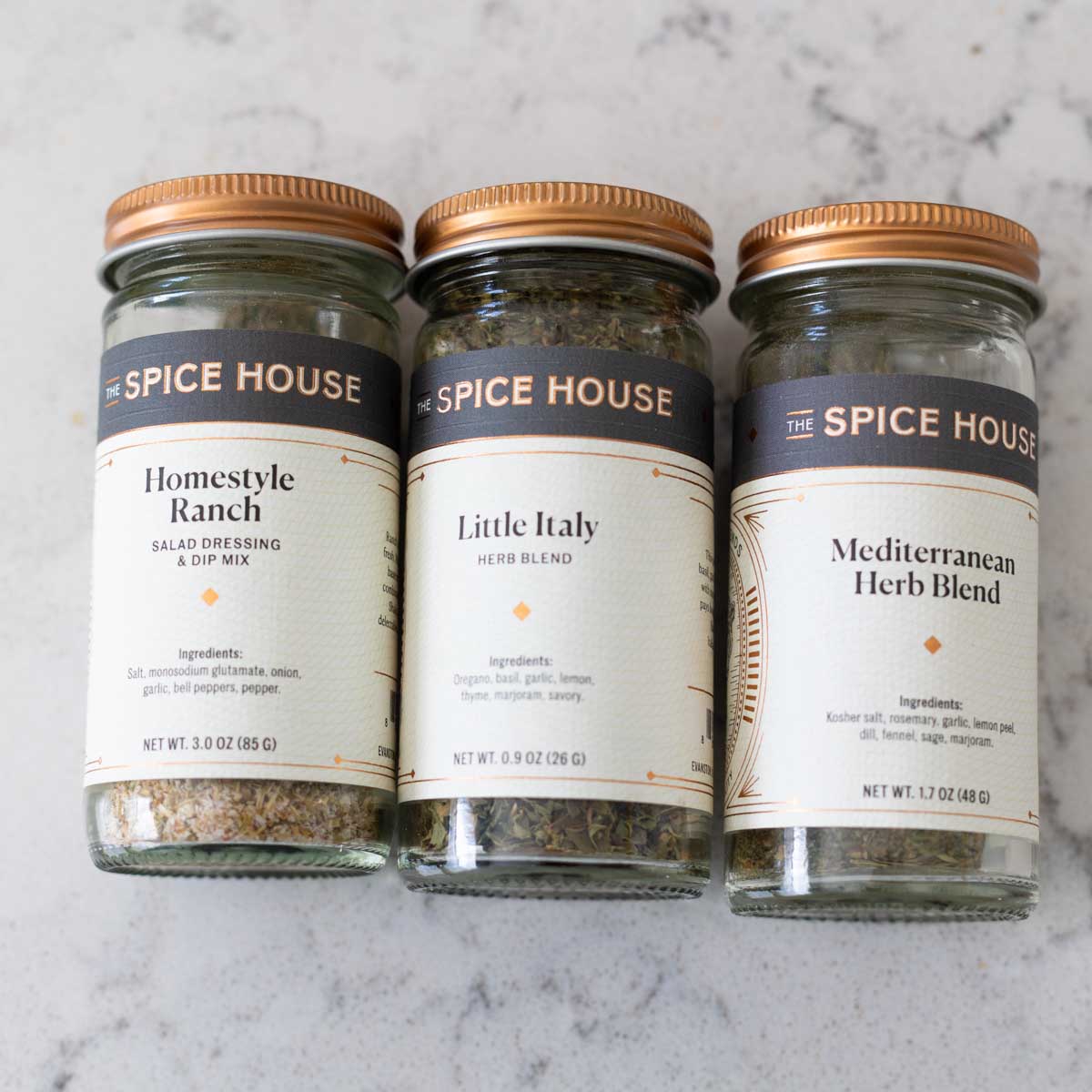3 jars of seasoning in a row to show options for changing up the dressing.