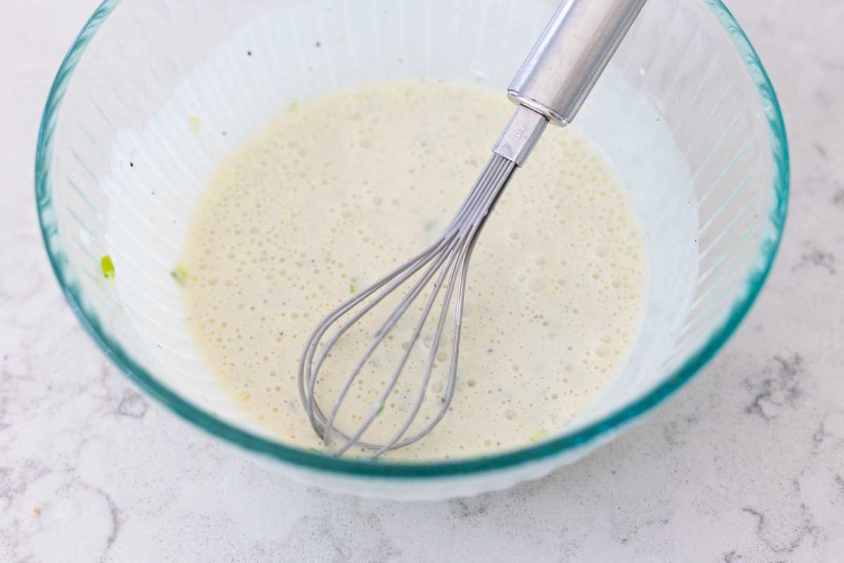 The finished dressing is shown in the mixing bowl to show consistency.