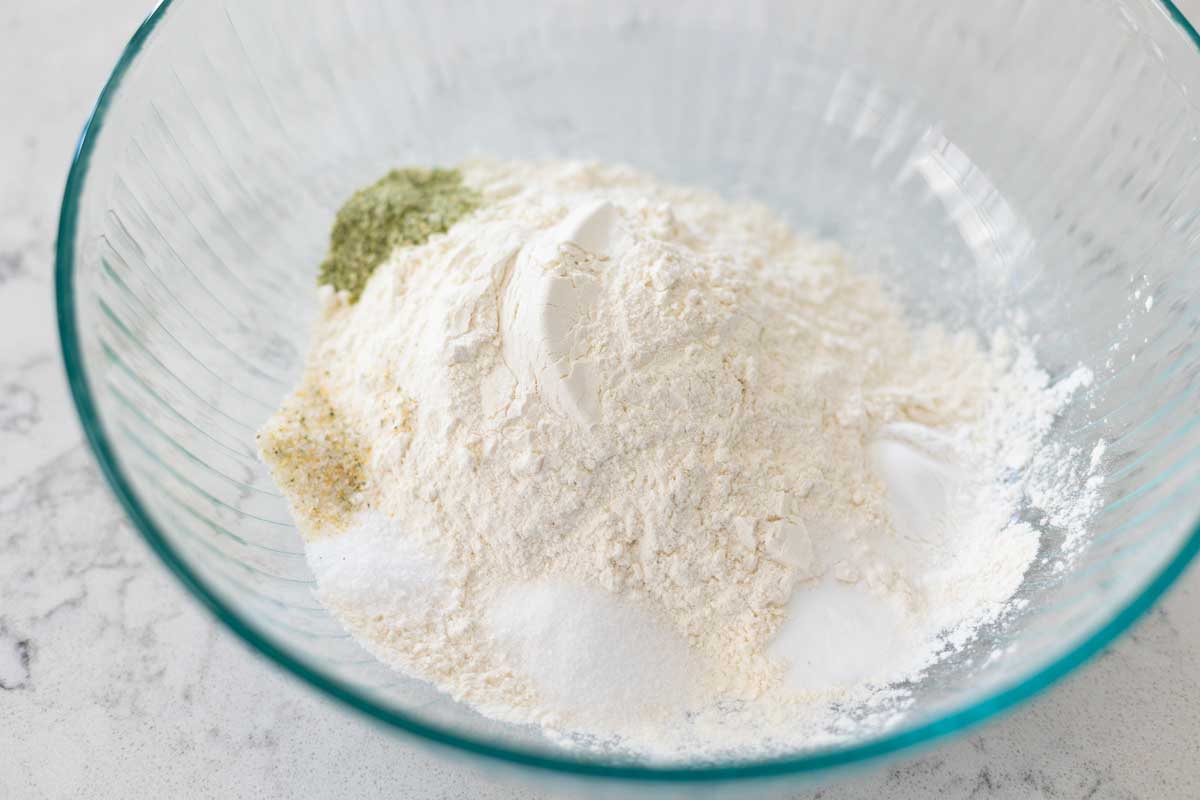 A mixing bowl has all the dry ingredients in it.