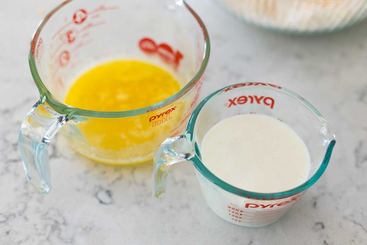 2 measuring cups, one with melted butter, one with buttermilk.