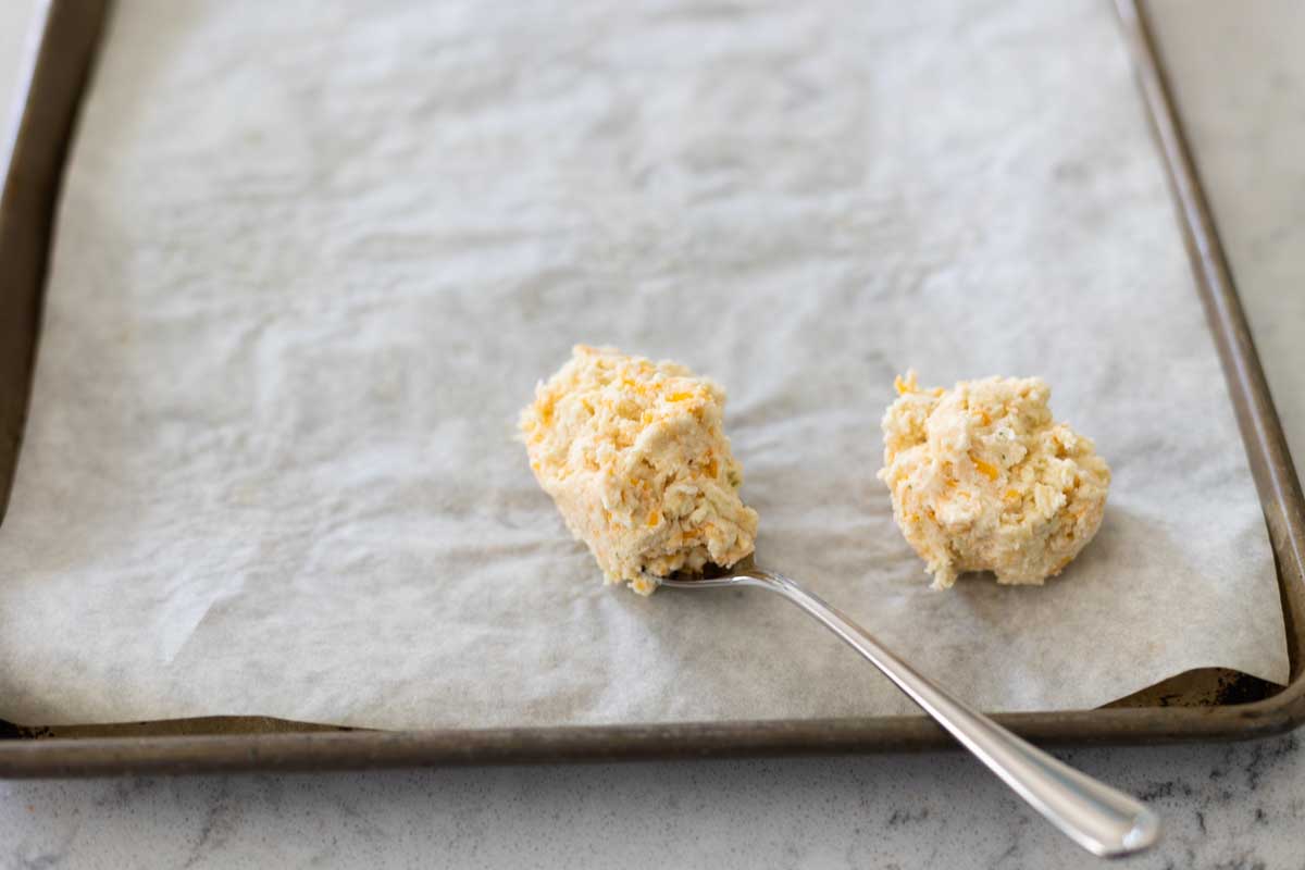 A spoon shows how big to make the biscuit drops.