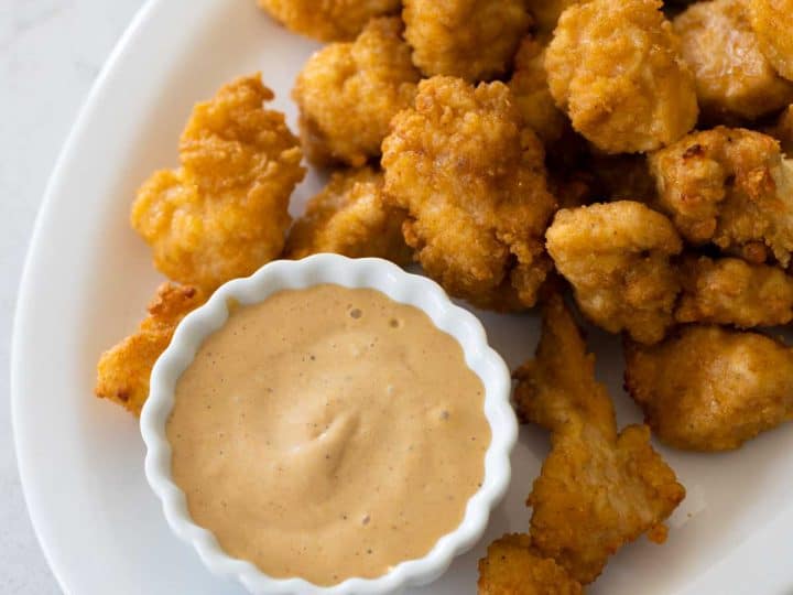 A platter of chicken nuggets has a cup of copycat Chick-Fil-A sauce for dunking.