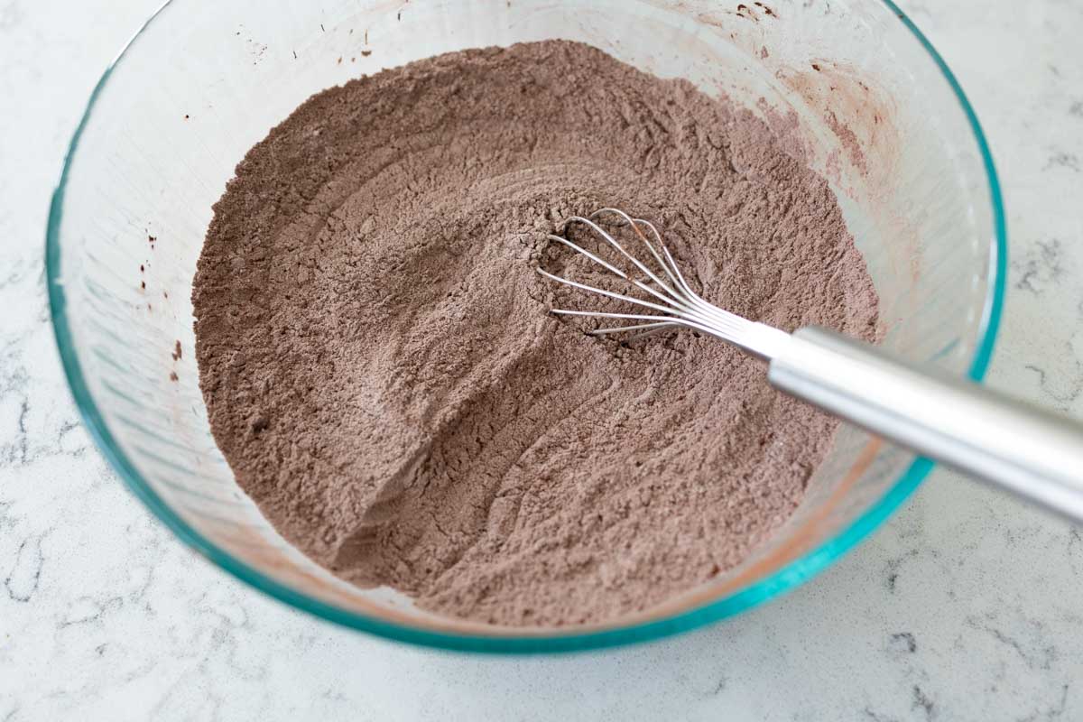 The chocolate powder has been whisked into the flour and sugar.