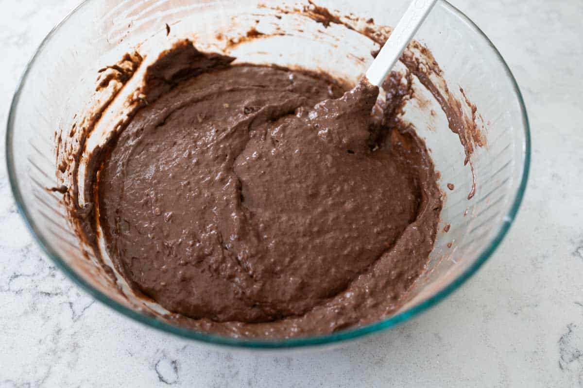 The chocolate waffle batter has been stirred together and looks a little bit lumpy.