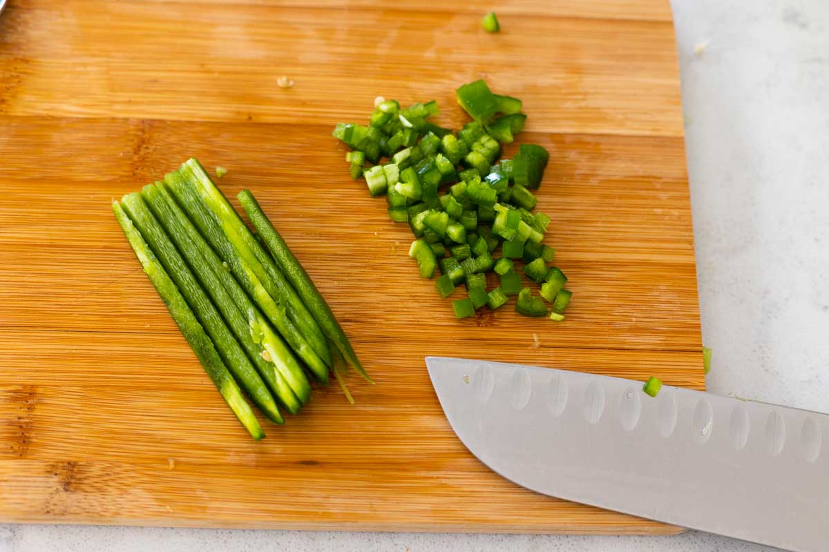 The fresh jalapeno has been sliced into thin strips and then chopped into a fine mince.
