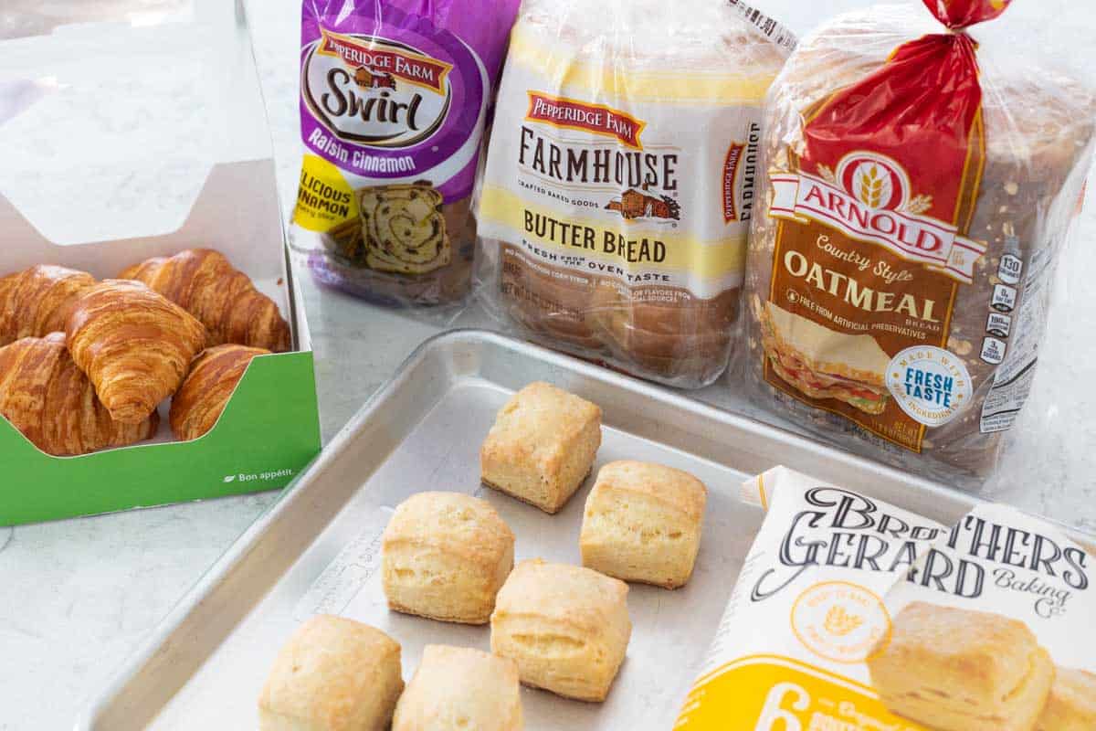 A variety of breads on the kitchen counter.