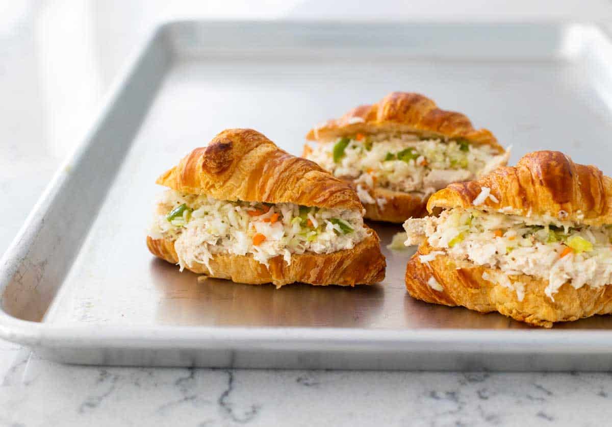 A baking pan holds 3 assembled mini sandwiches.