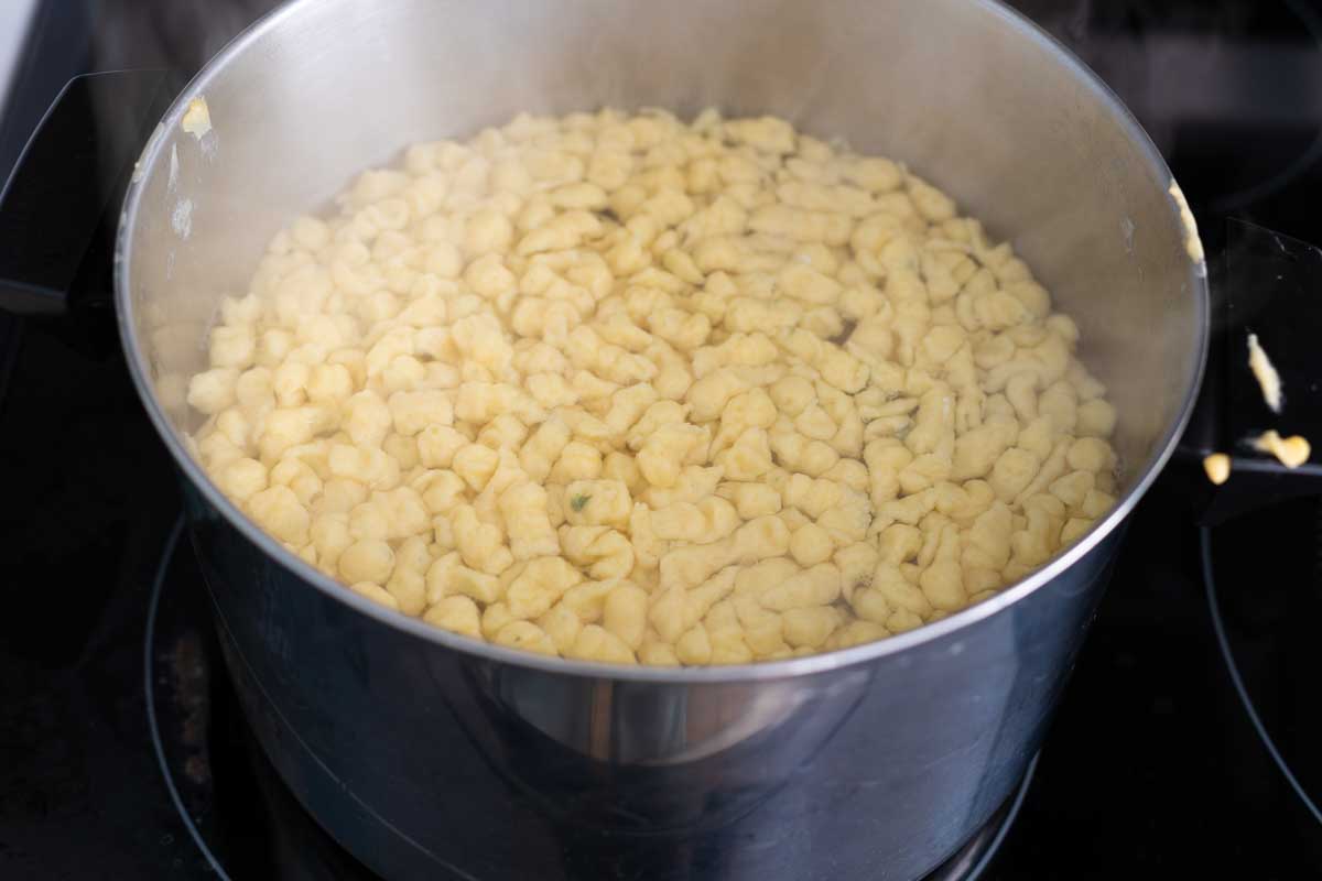 The spaetzle have floated to the top of the pot.