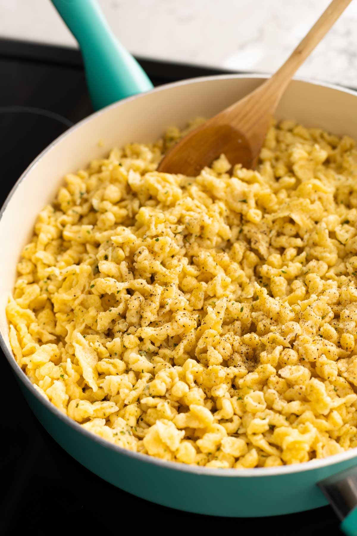 The spaetzle have been browned in melted butter in a large skillet.