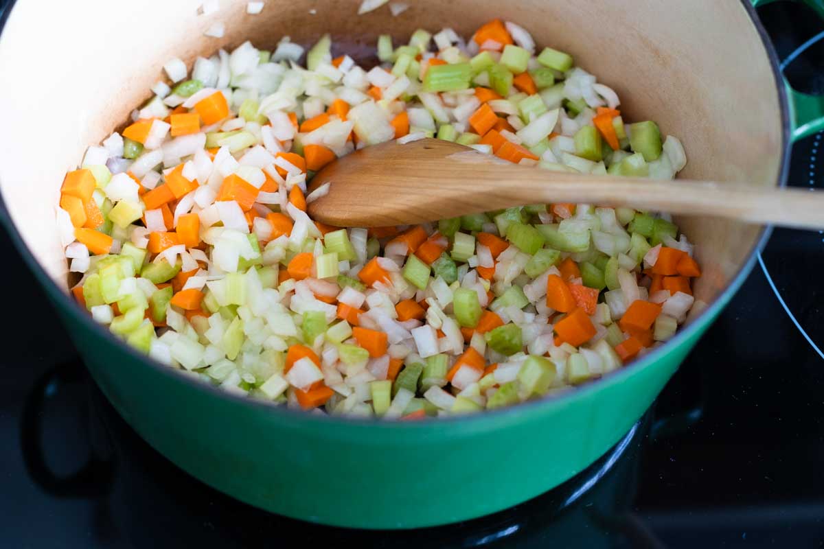 The chopped vegetables have been added to a large pot.