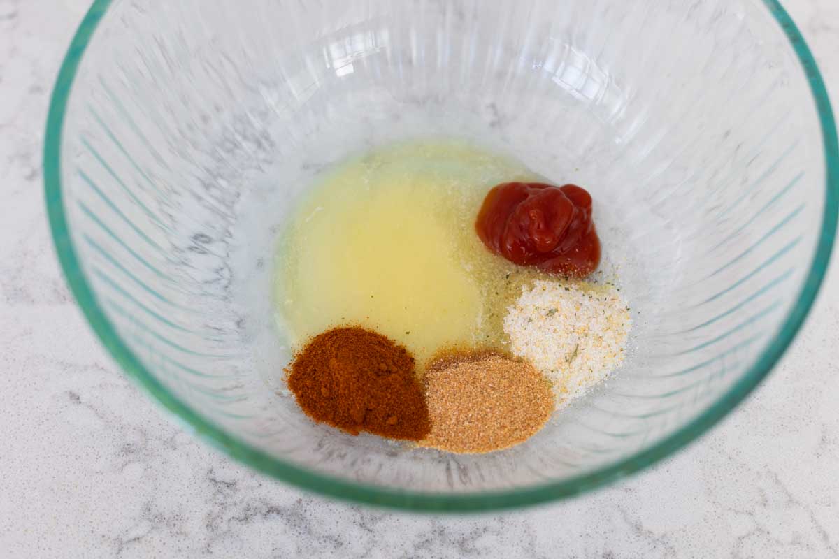 The spices and melted butter are in a mixing bowl.