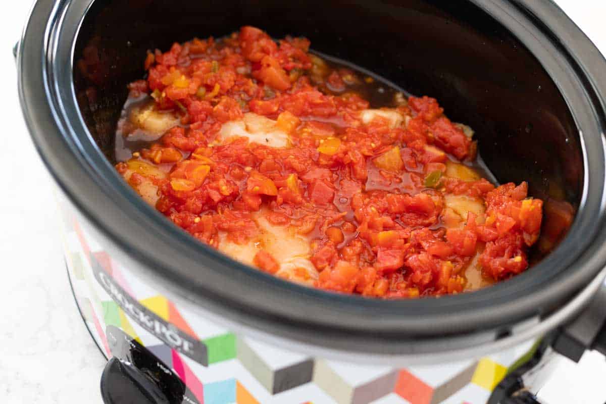 The can of diced tomatoes is spread on top.