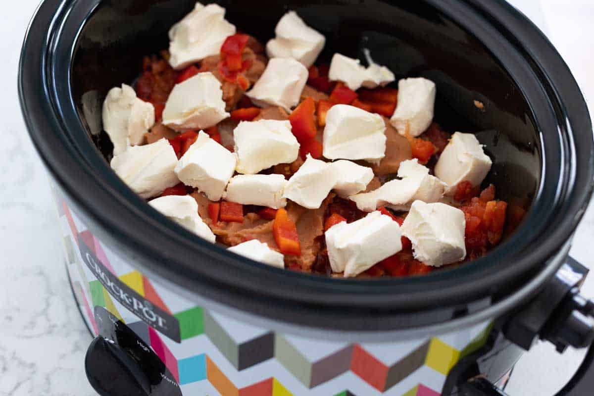 A brick of cream cheese has been cubed and scattered on top.