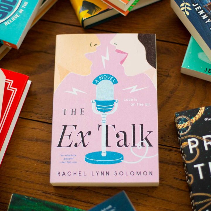 A copy of the book club book The Ex Talk by Rachel Lynn Solomon is on the table.