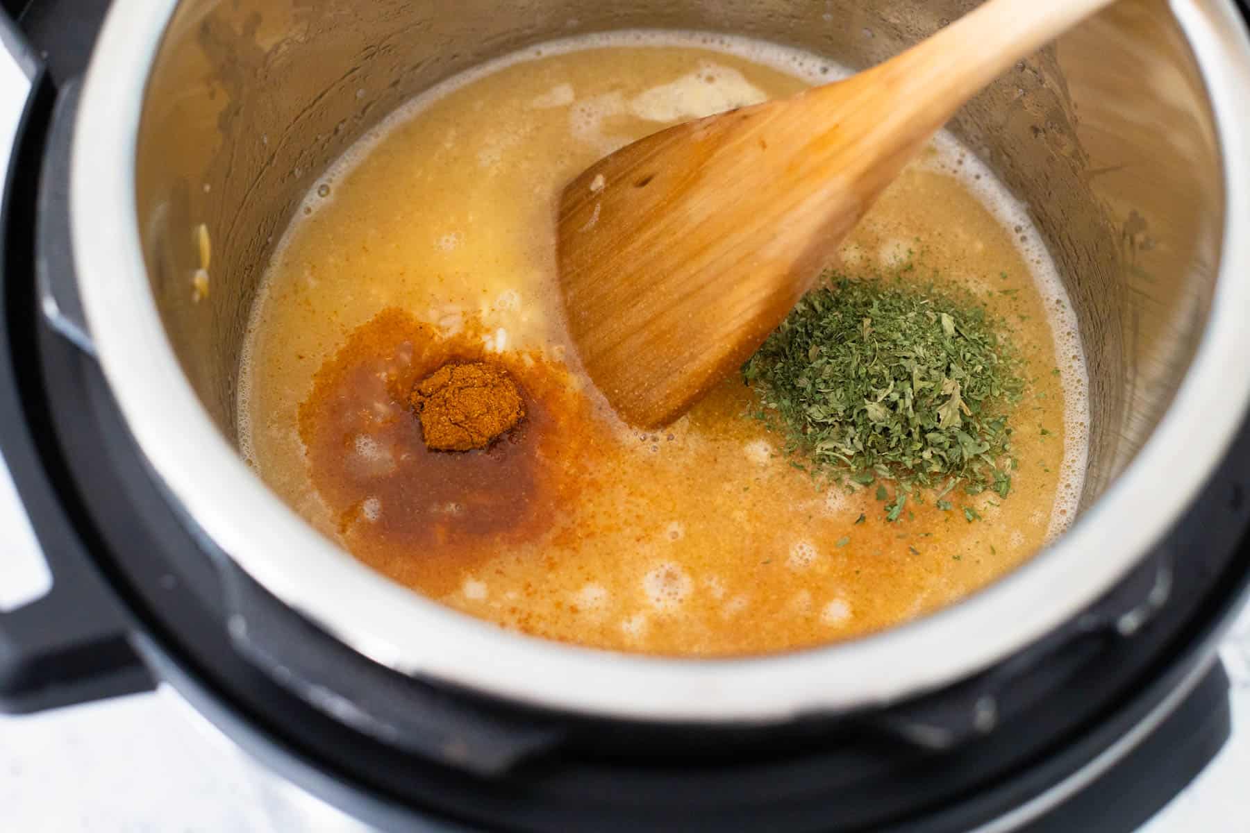 The chicken stock and seasonings have been added to the Instant Pot.