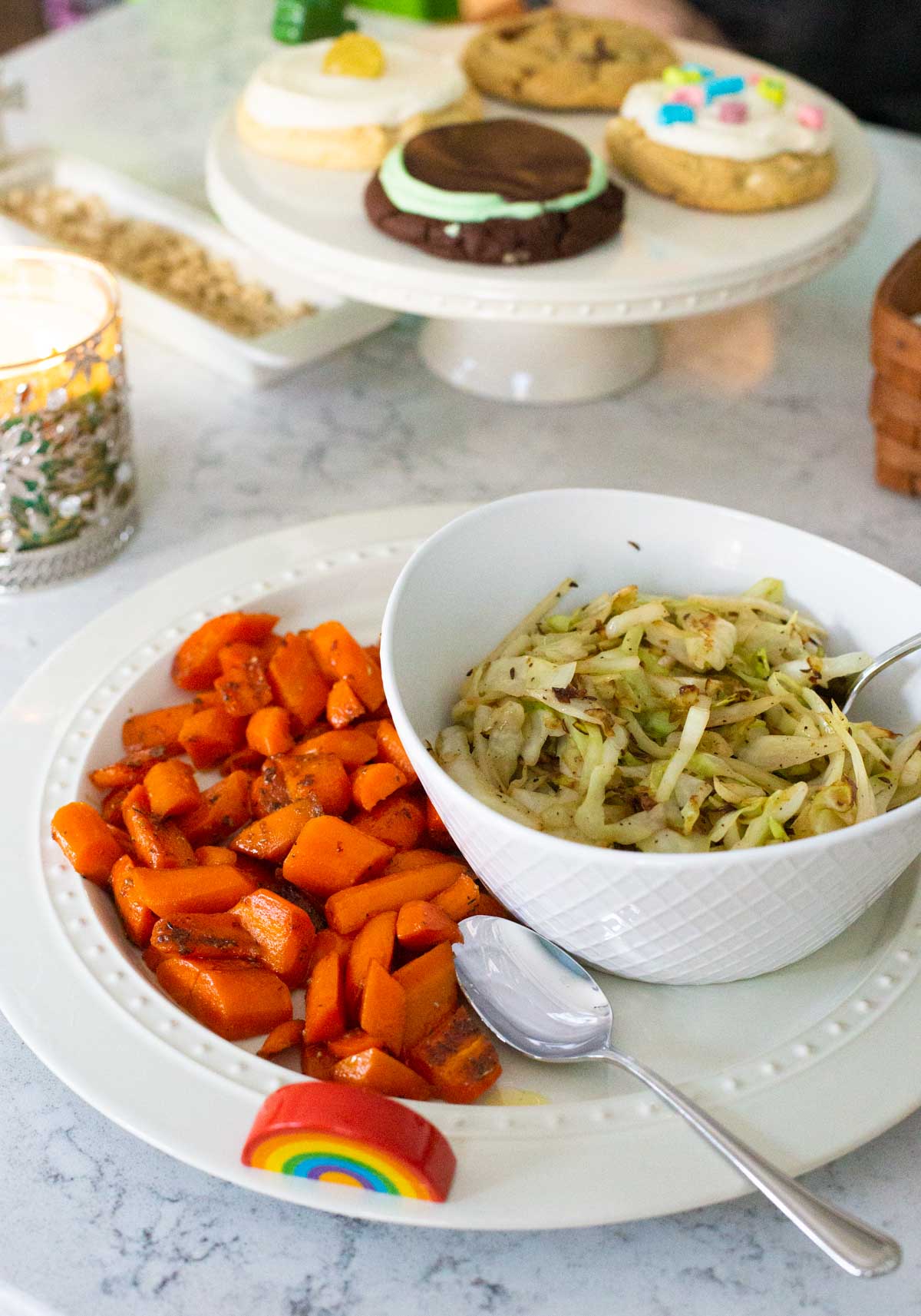 Glazed carrots and a bowl of fried cabbage are ready to be served.