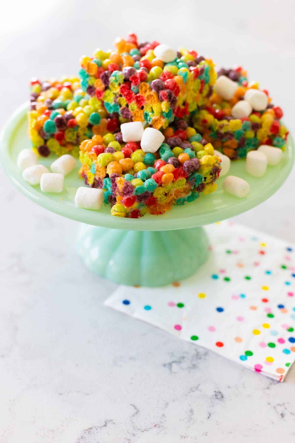 A cake plate with the treats on top.