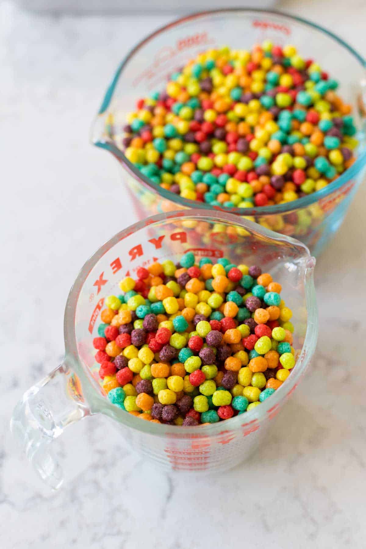 Two measuring cups hold the cereal.