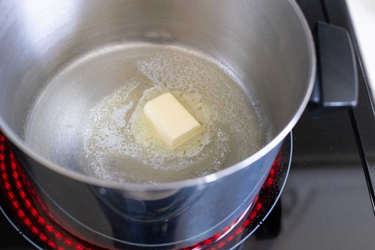 The butter is melting in a large pot.