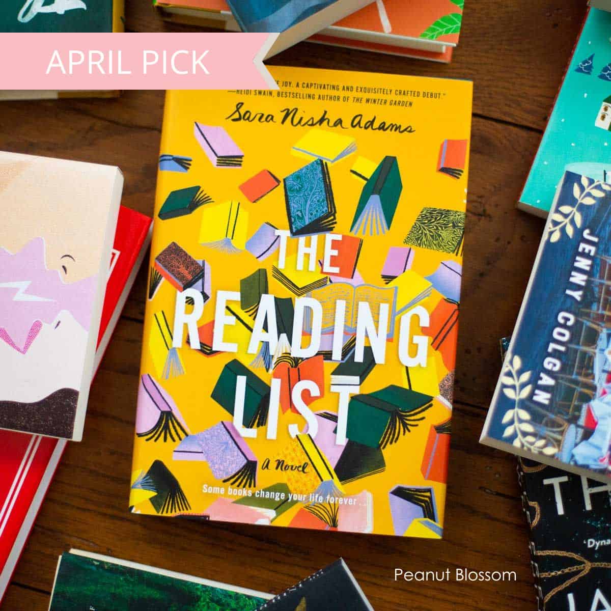 A copy of The Reading List sits on a table surrounded by other books.