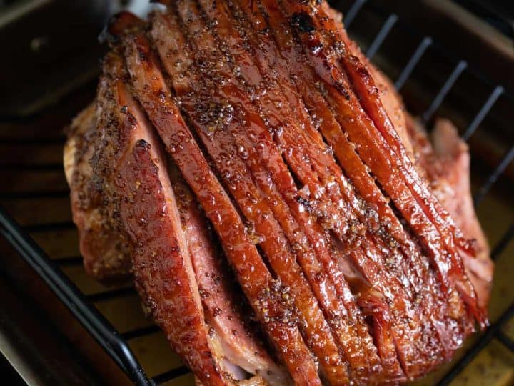 The spiral ham is on a roasting rack so it can be broiled to make the brown sugar glaze crispy.