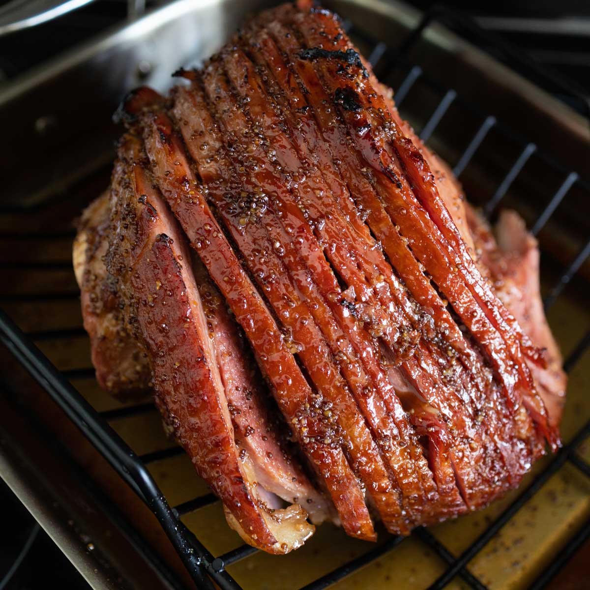 The spiral ham is on a roasting rack so it can be broiled to make the brown sugar glaze crispy.