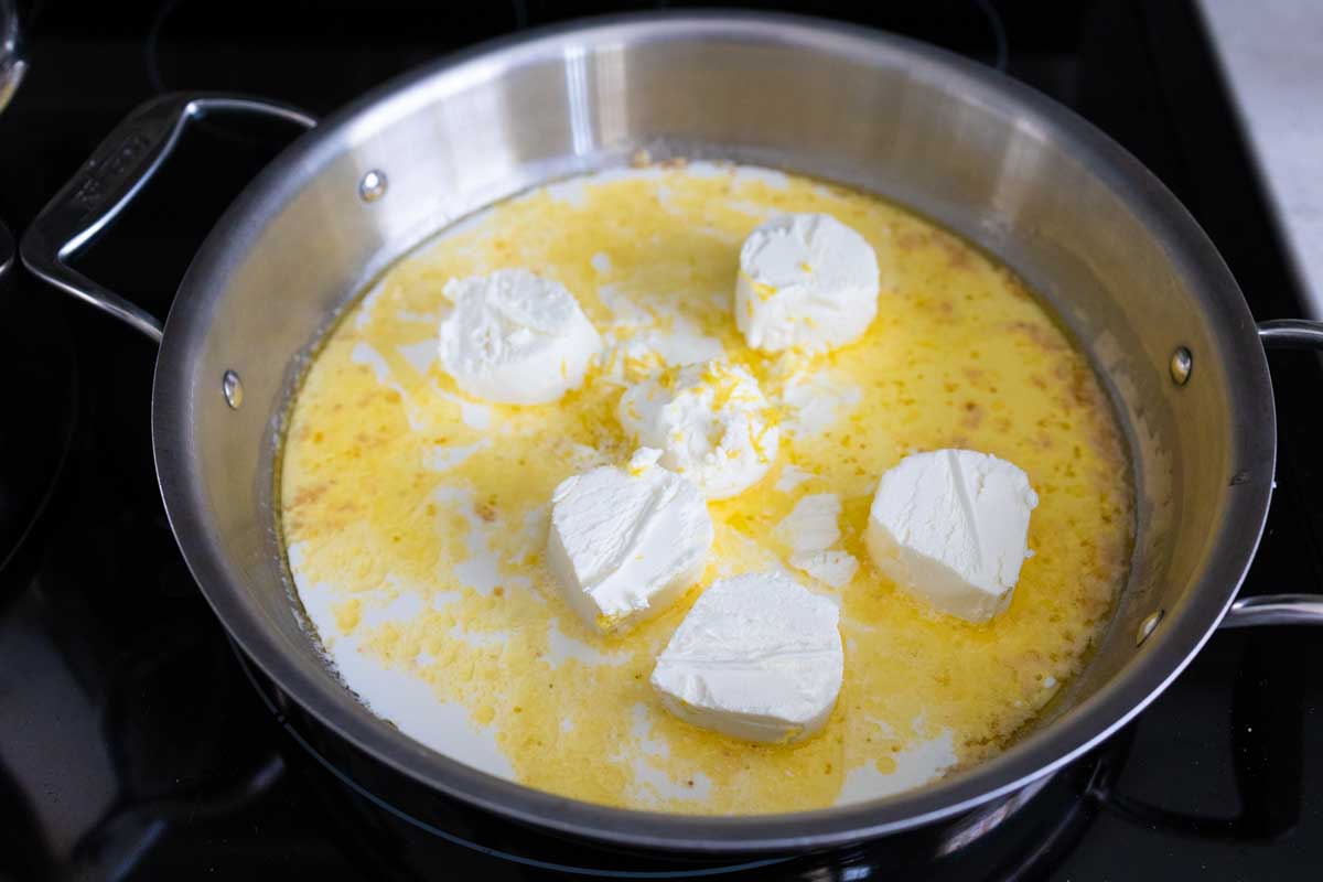 The cheese has been cut into large chunks and is melting into the butter and milk.