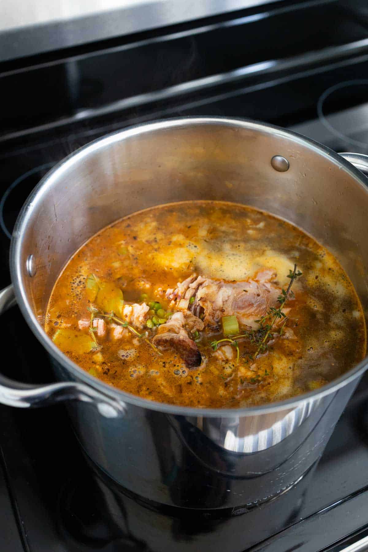 The peas have been added to the pot and the broth has been brought up to a simmer.