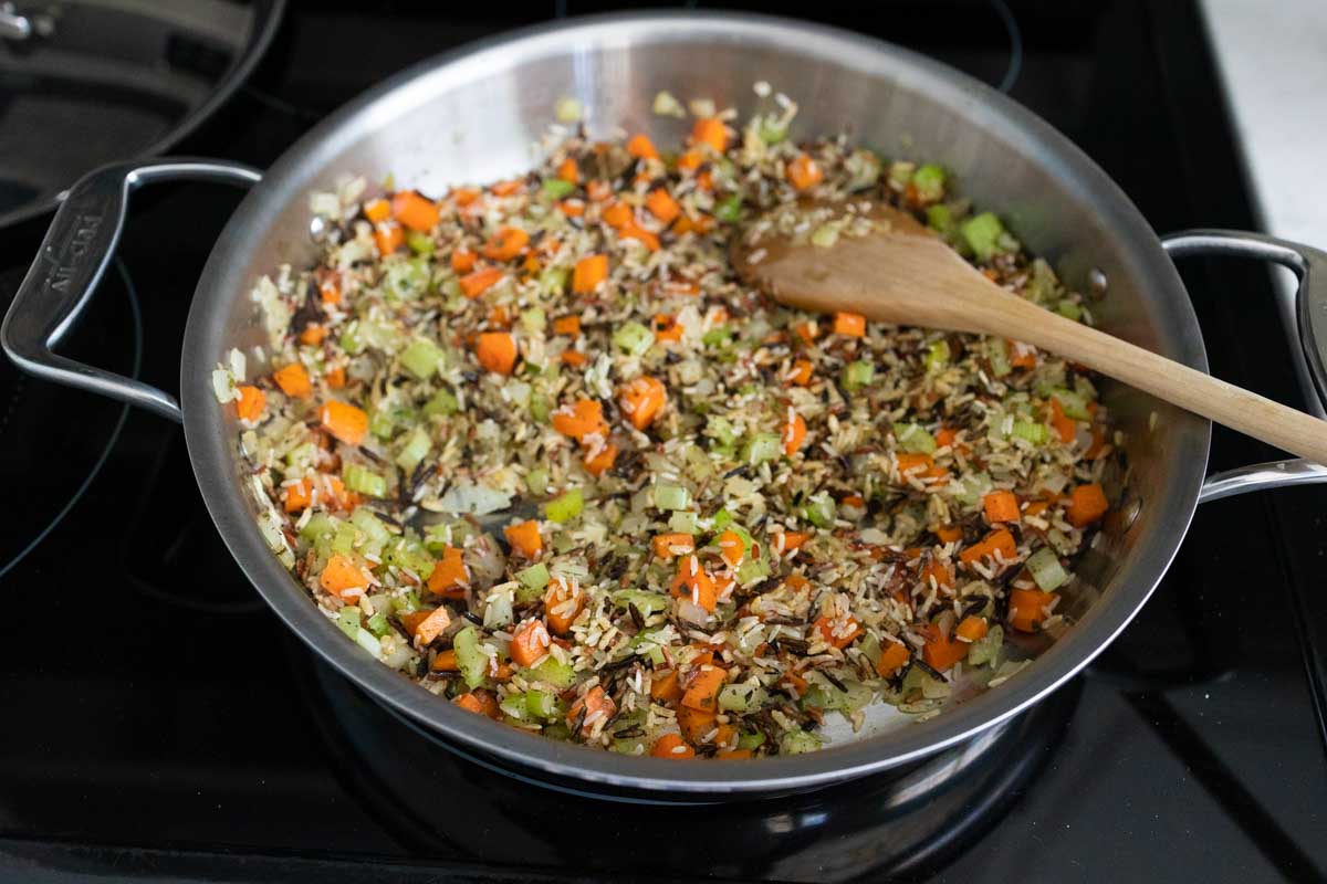 The wild rice blend has been added to the skillet.
