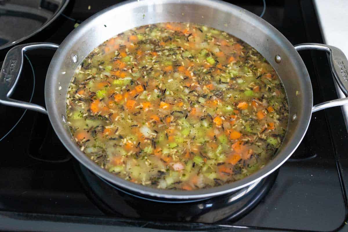 Chicken stock has been added to the skillet.