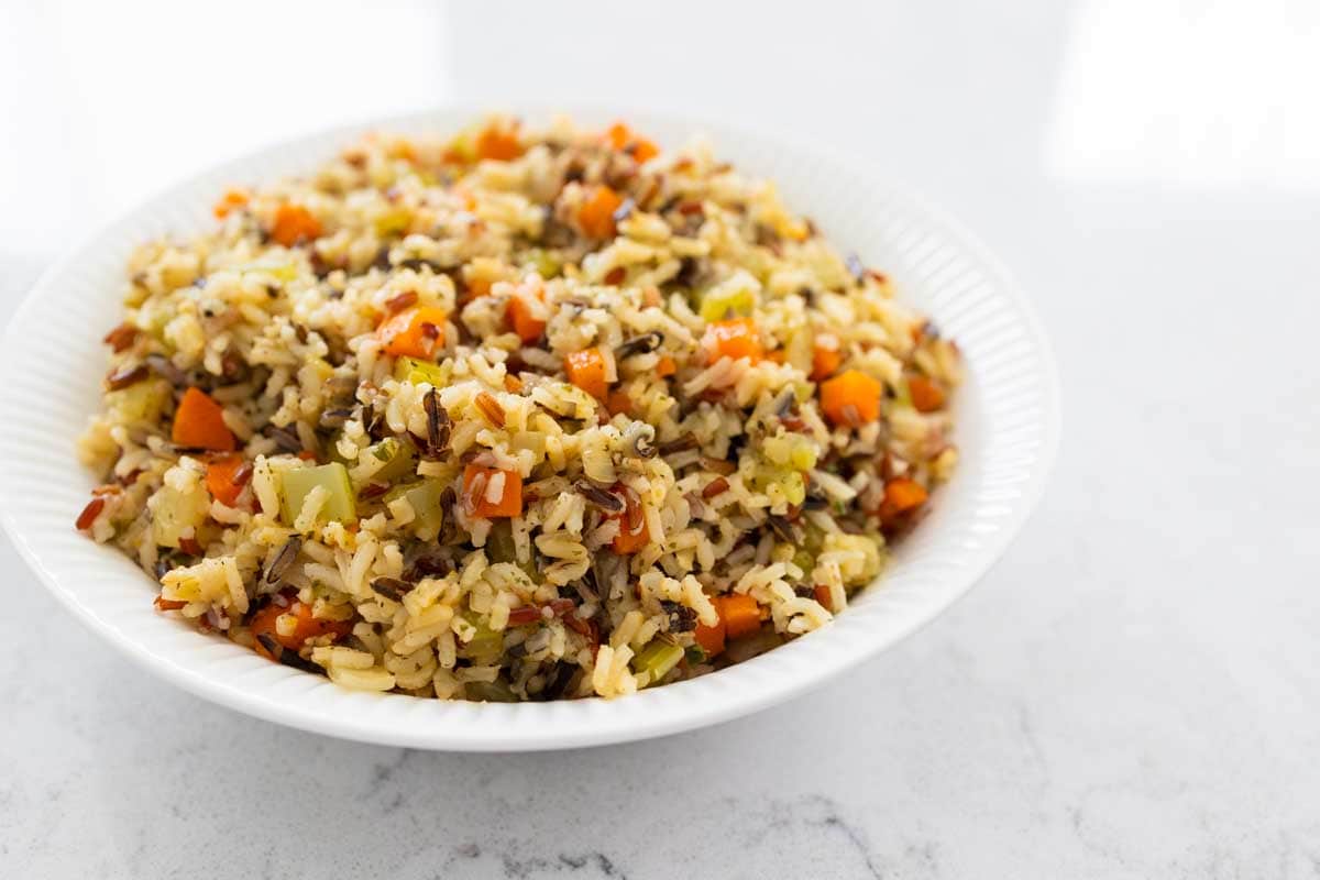 The rice pilaf is being served in a white bowl.