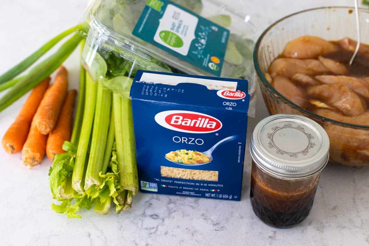 The ingredients to make the pasta salad are on the counter.