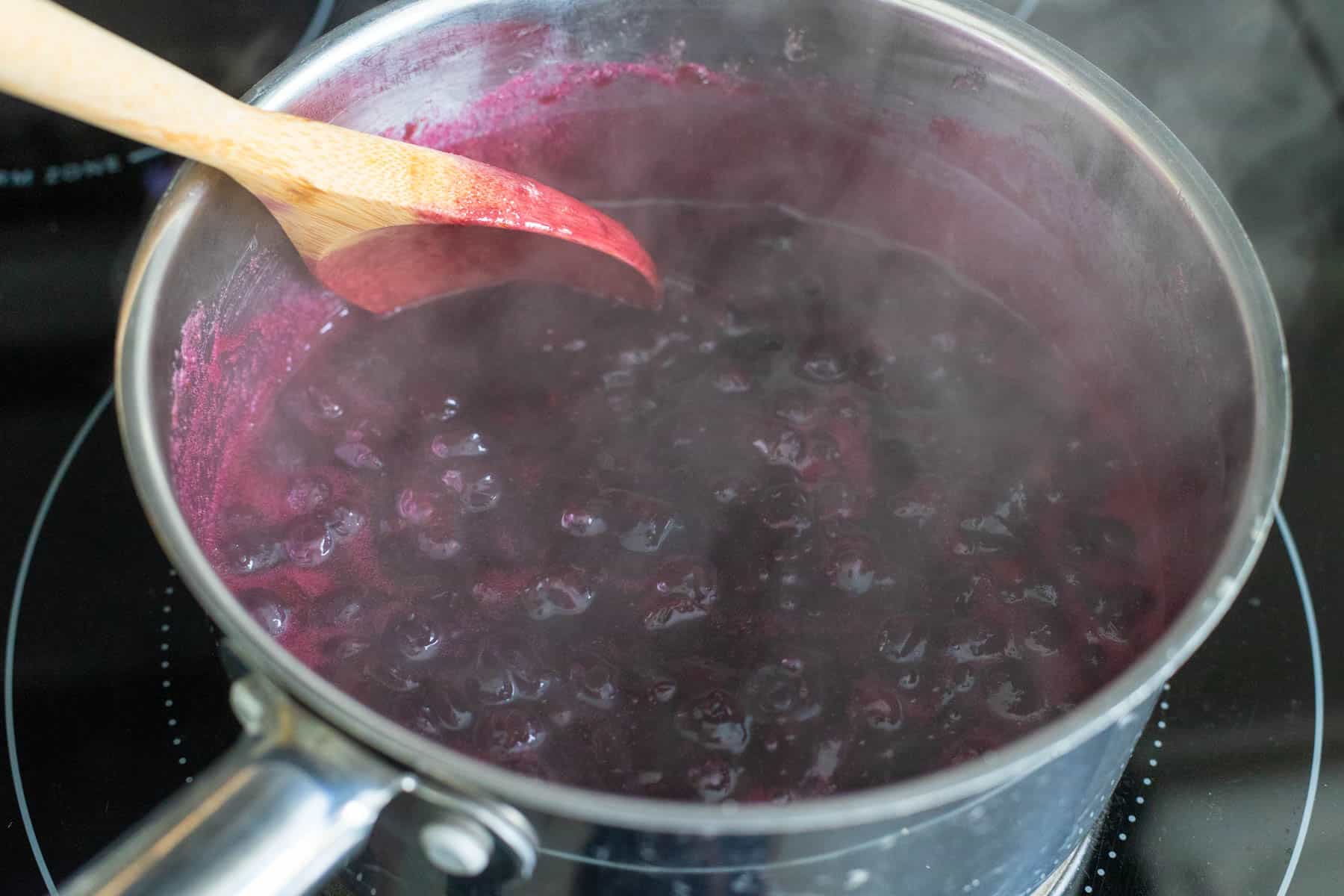 The blueberry mixture has come to a boil and is steaming vigourously.