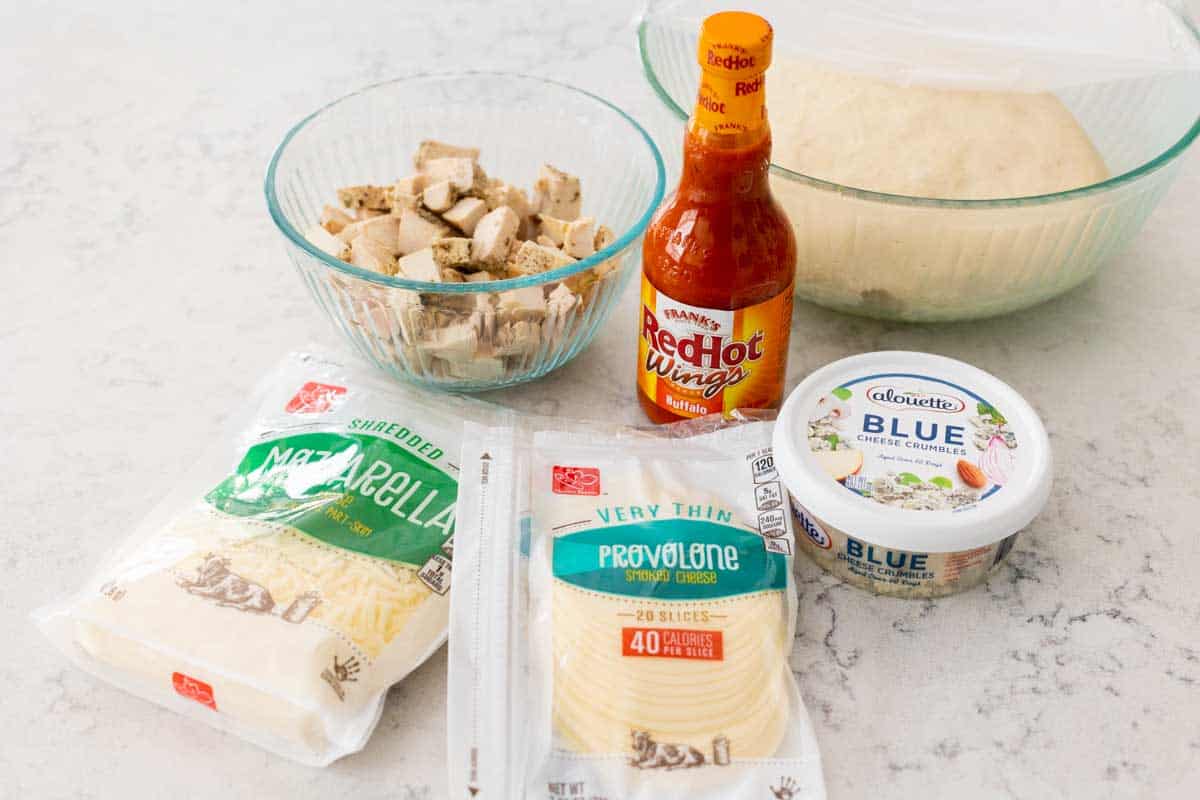 The ingredients to make the flatbread are on the counter.