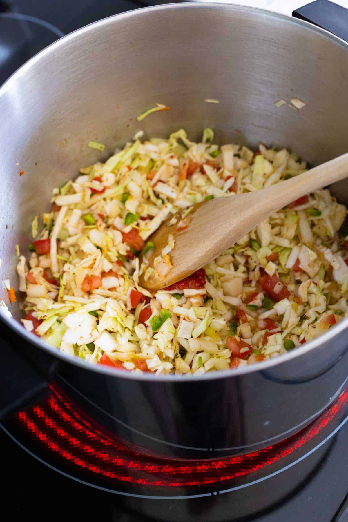 The relish is cooking over medium-high heat to come to a simmer.