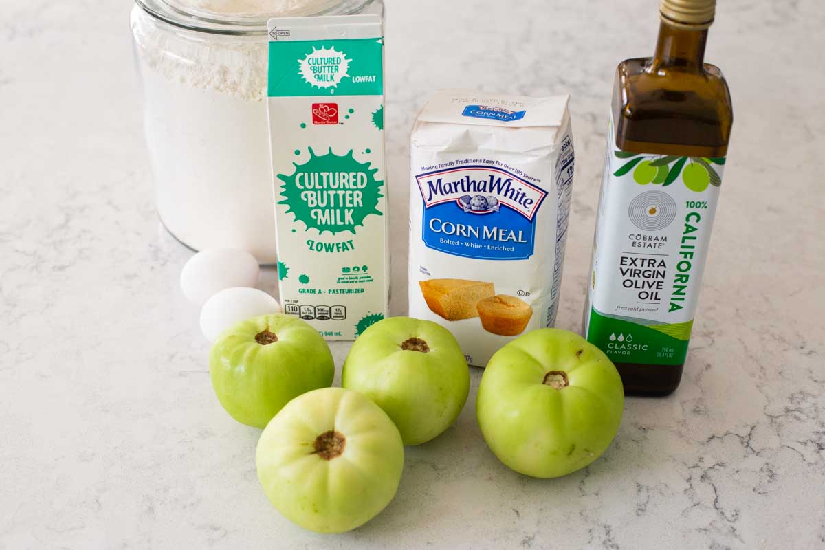 The ingredients to make fried green tomatoes are on the counter.