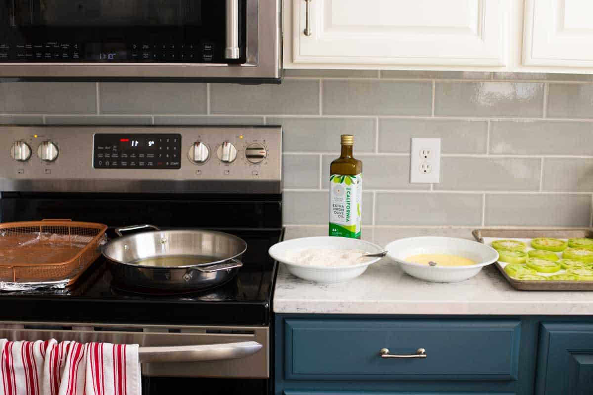 The kitchen is set for frying the tomatoes with all the elements lined up near the stove.