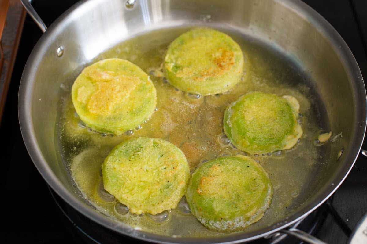 The tomatoes have been flipped and show the golden brown coating.