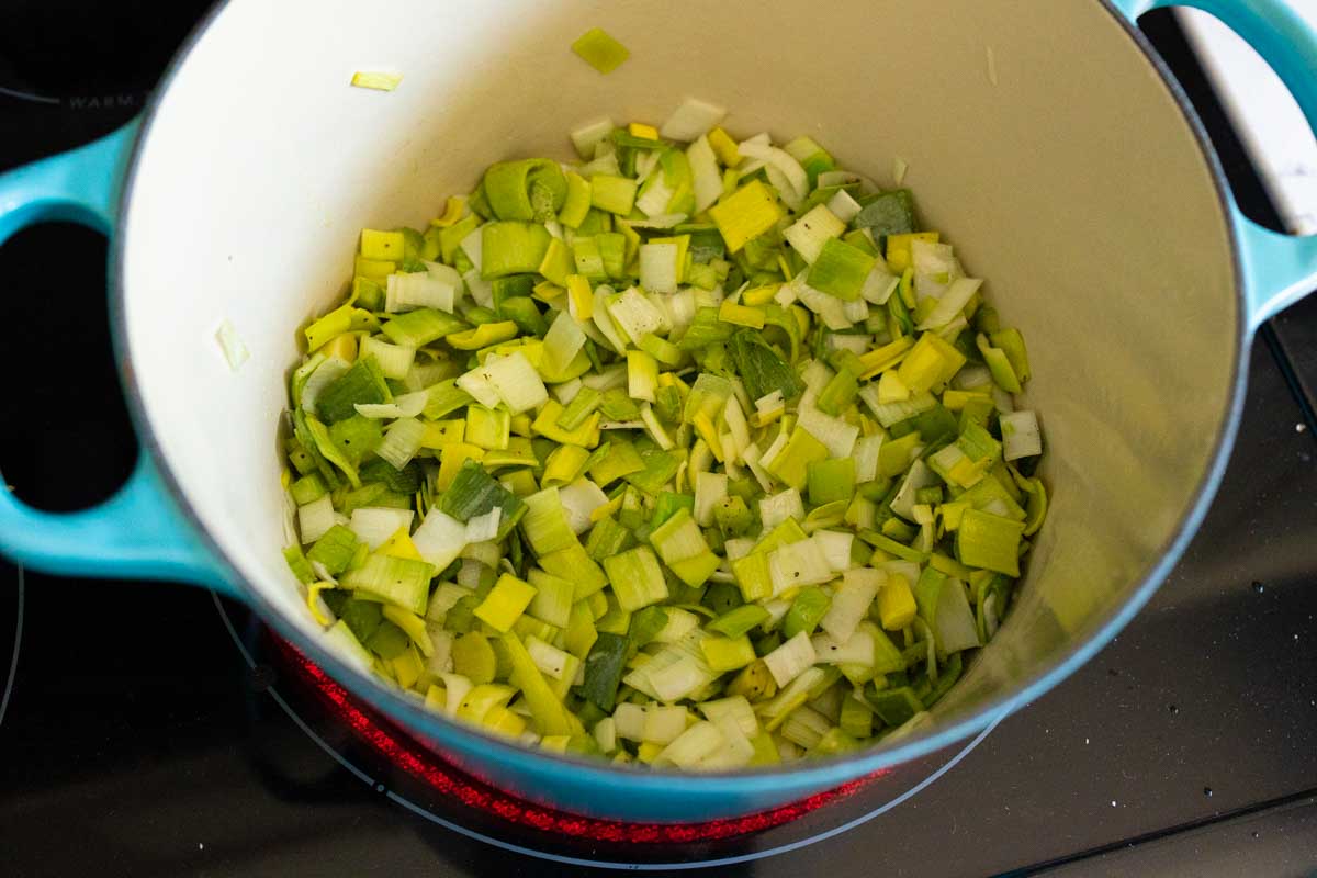 The chopped leeks are cooking in butter in the soup pot.
