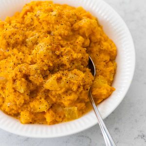 The serving bowl is filled with the mashed sweet potatoes.