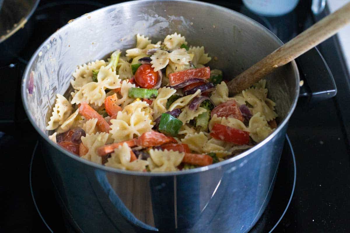 The final dish is being tossed together in the big pot.