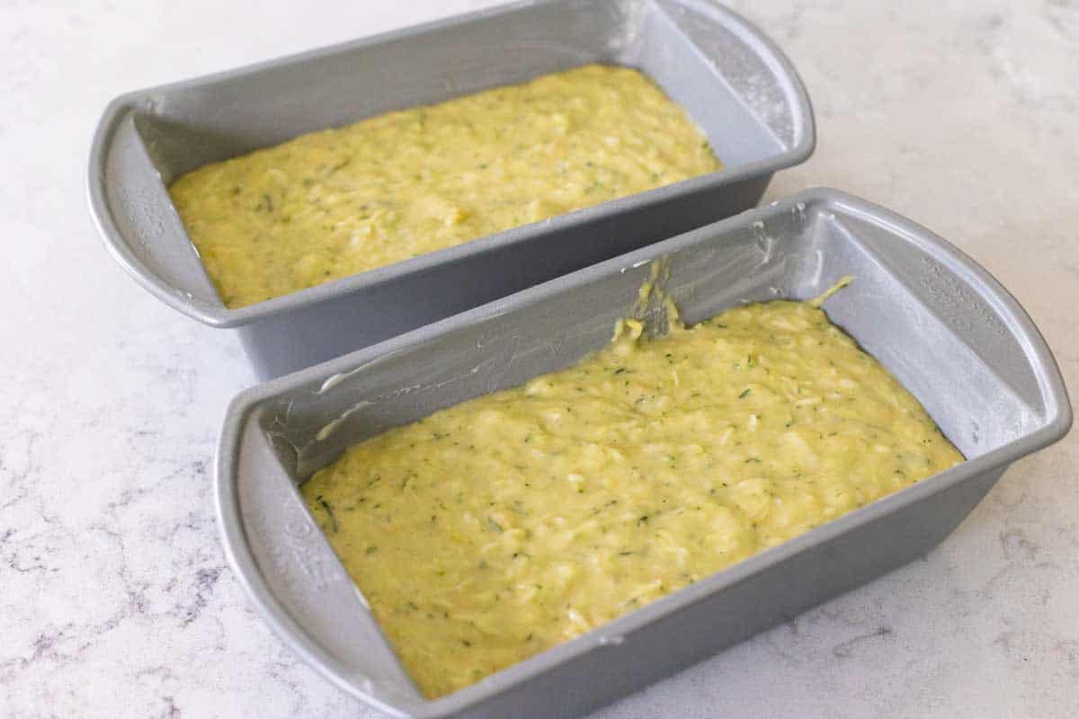 Two baking pans have been filled with the final quick bread batter.