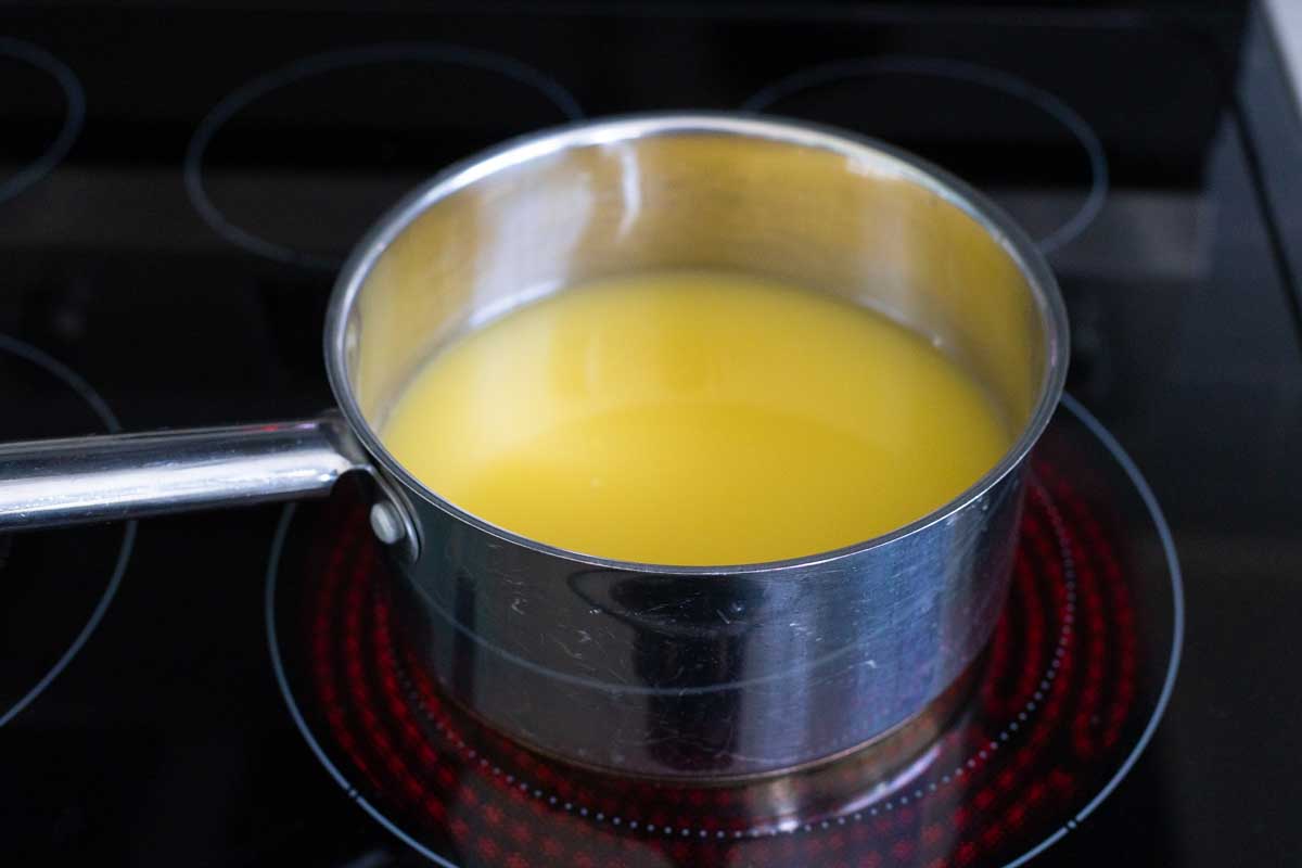 The orange juice and water are in a saucepan.