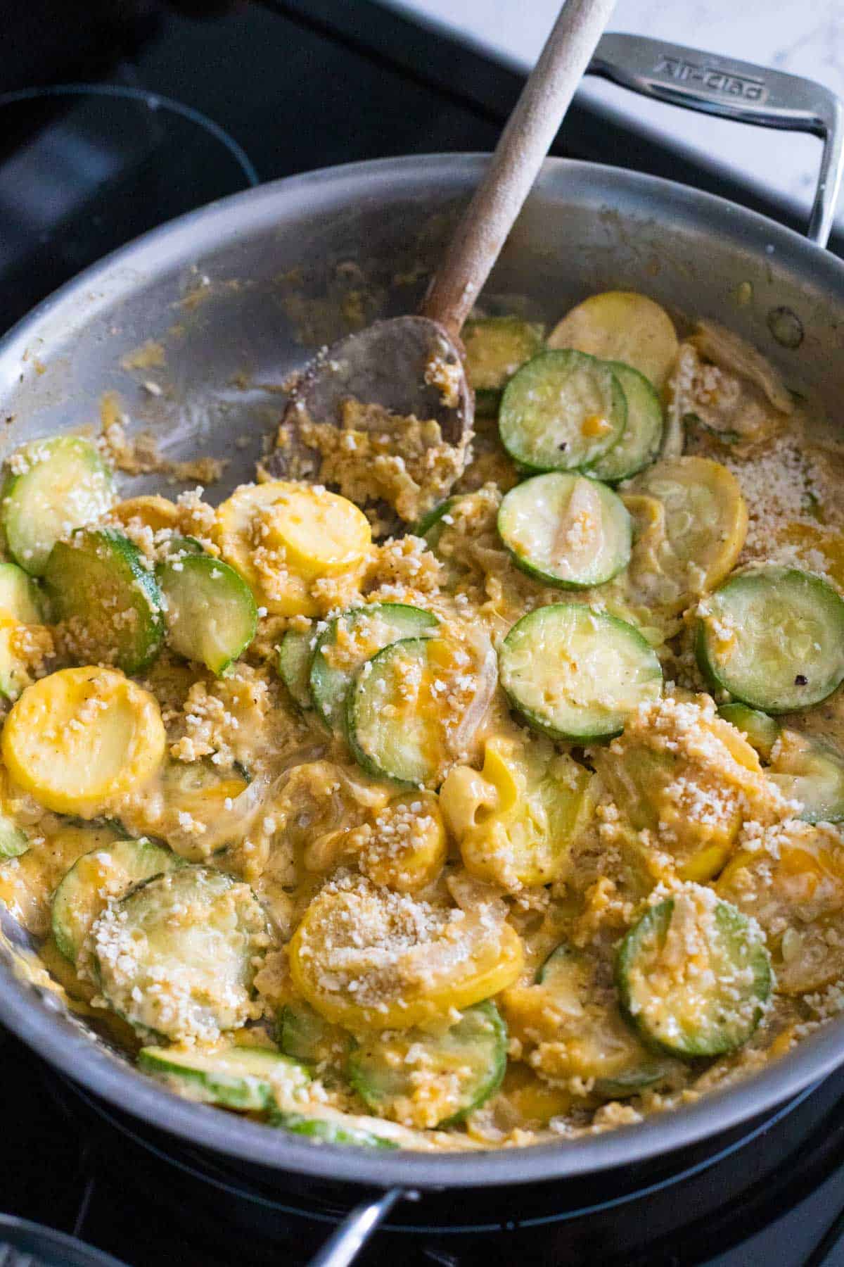 The finished squash casserole is about to be served from the skillet.