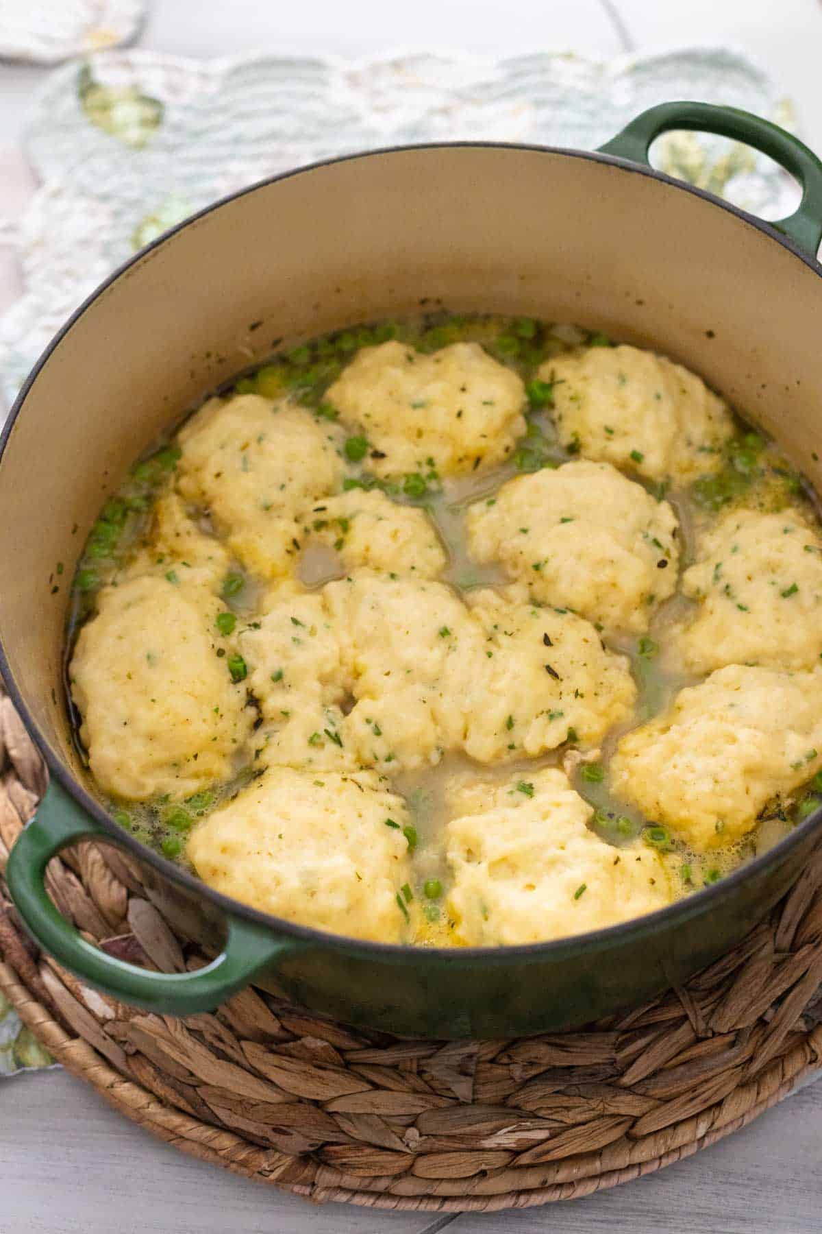 The finished chicken and dumplings are being served from the Dutch Oven at the table.