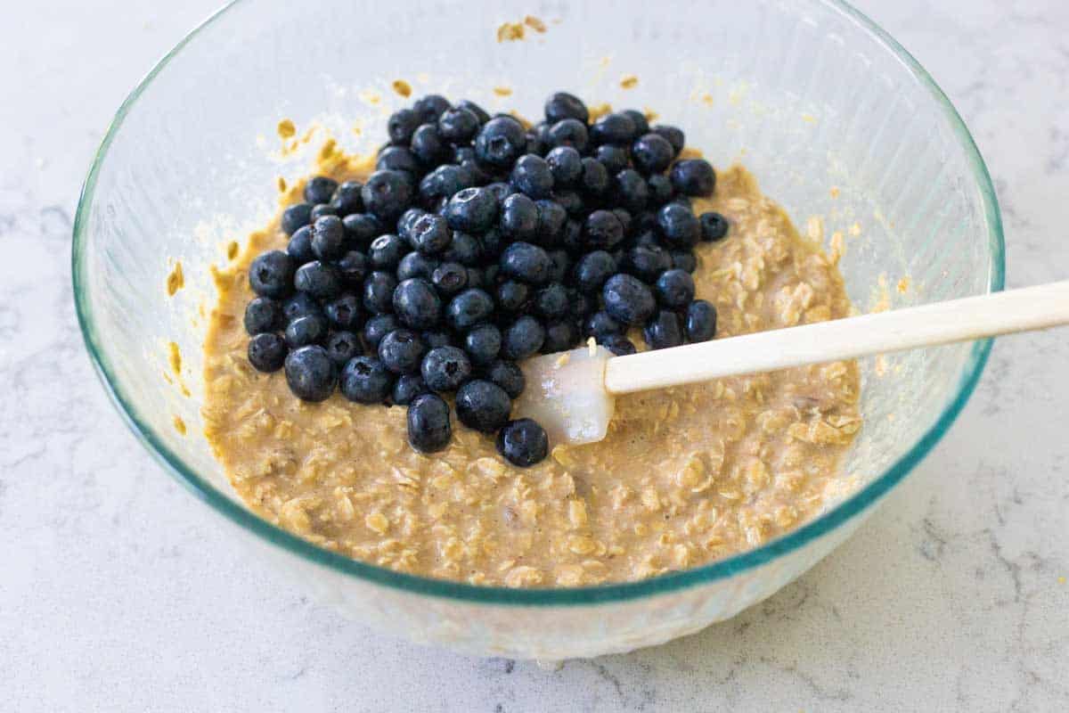 The blueberries have been added to the mixing bowl.